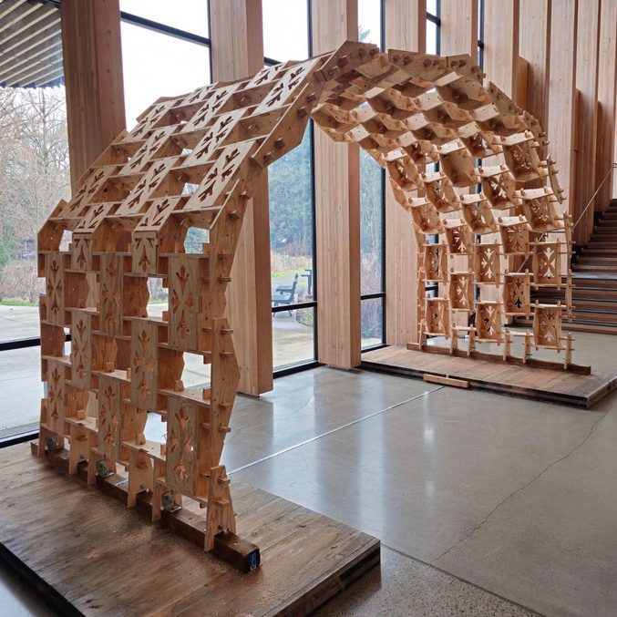 Arched pavilion made of reciprocal frame components installed in Oregon State University's Peavy Hall